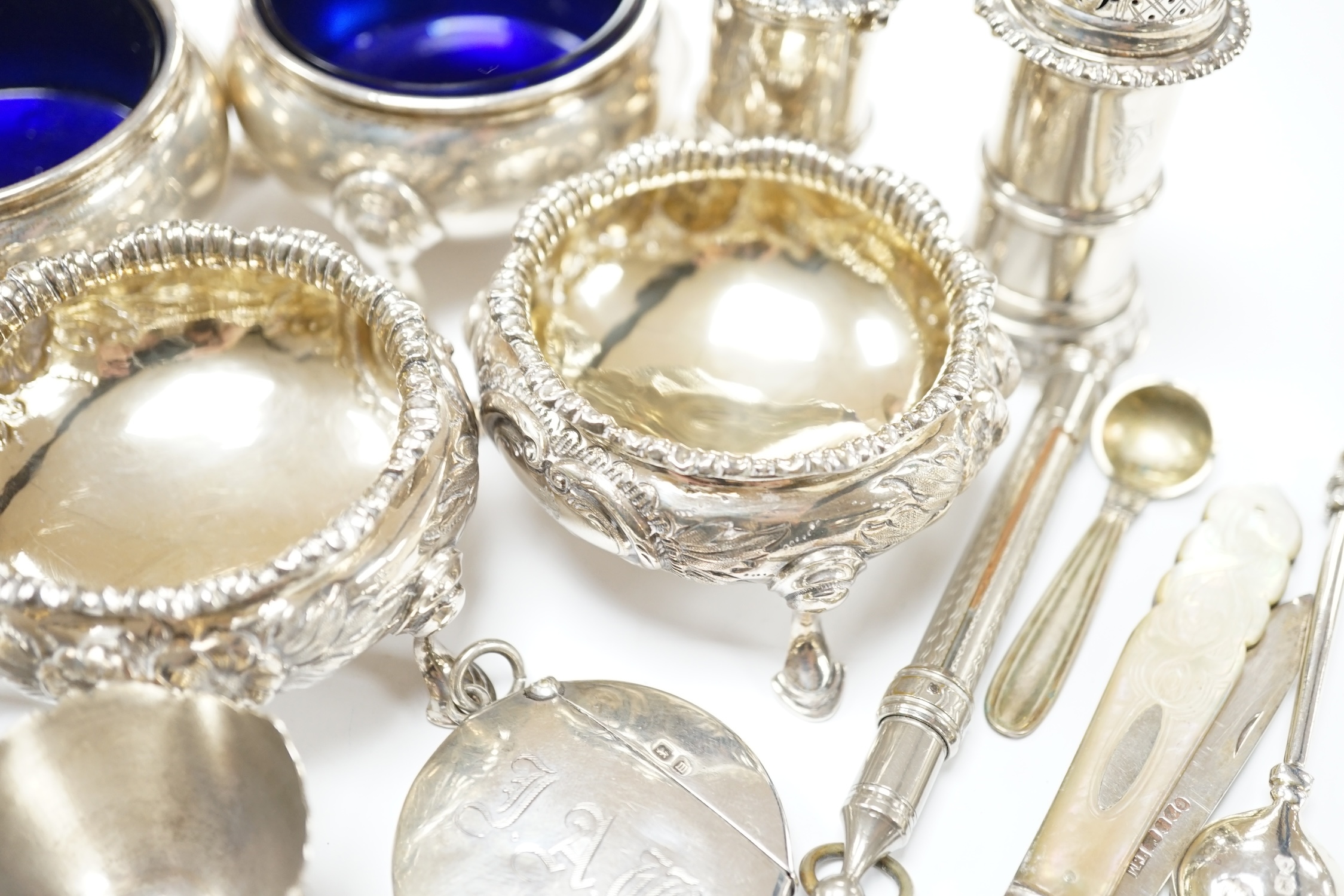 A pair of George II silver bun salts, London, 1735, diameter 60mm, a later pair of Victorian silver salts, a pair of Edwardian silver pepperettes by William Comyns and sundry other items including a circular silver vesta